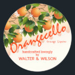 Modern Orangecello Orange Classic Round Sticker<br><div class="desc">Oranges nestled in flowers and green leaves.</div>