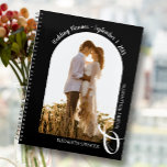Modern Photo Arch Black Wedding Planner<br><div class="desc">An elegant spiral-bound planner with 60 pages and 12 months, features a single vertical or portrait-oriented wedding photo in a unique arched layout. CHOOSE SOFT OR HARD COVER. Your names are joined with a large white ampersand at the bottom and your wedding date arched at the top. Change the color...</div>