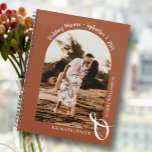 Modern Photo Arch Terracotta Wedding Planner<br><div class="desc">An elegant spiral-bound wedding planner calendar features your photo in a unique arched layout on a terracotta background, your names joined with a large white ampersand at the bottom and your wedding date arched at the top. Change the color of the book on the front and back to match your...</div>