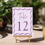 Modern Purple Wavy Frame Wedding Table Number<br><div class="desc">Add a stylish touch to your wedding celebration with these Modern Wavy Frame wedding table cards! The retro design displays "Table" in a handwritten purple script with the table number shown below. A dark purple wavy border surrounds the table number contrasting with a light purple background. The design repeats on...</div>