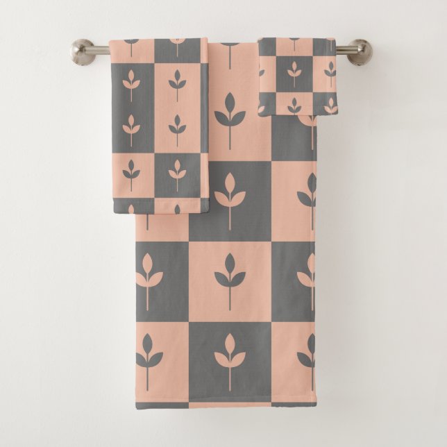 Modern repeating leaf pattern pink and grey bath towel set (Insitu)