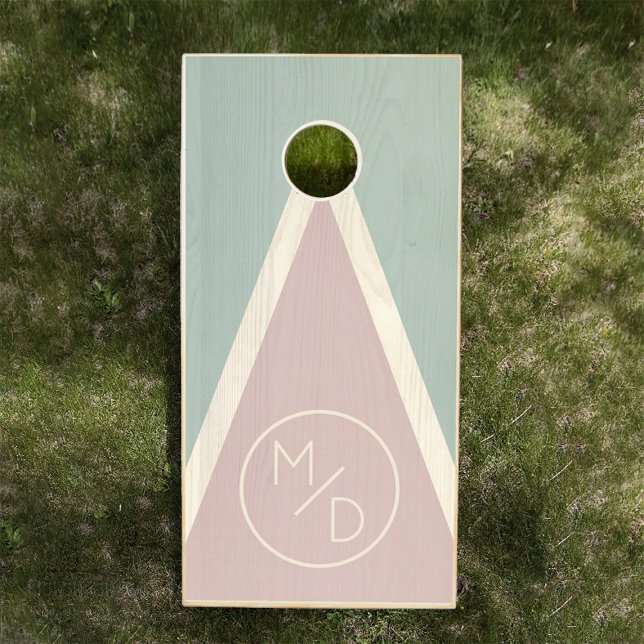Modern Romantic Blush Sage Monogram Wedding Cornhole Set (A cornhole board on grass features pastel sage, pink, and beige triangles and monogrammed initials )