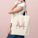 Modern Rose Gold Monogram Initial and Name Tote Bag<br><div class="desc">Elegant and feminine,  this tote features a large rose gold monogram initial with a personalized name in flowing dark script. A versatile monogram design that makes a beautiful bridesmaid proposal gift,  birthday present,  or everyday accessory for any woman who appreciates refined style. Initial and name are fully customizable.</div>