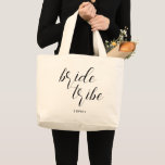 Modern Script Bride Tribe Bridesmaid Name Large Tote Bag<br><div class="desc">Surprise your bridesmaids with personalized bridal party gifts and use this tote bag to bundle all together. This stylish modern and minimalist tote bag features "bride tribe" in a modern calligraphy style script. Personalize the name on the front of the bridesmaid tote. Both the calligraphic word and the name can...</div>