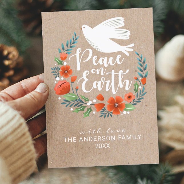 Modern Script Peace on Earth Christmas Photo Holiday Card (A beautiful Christmas card featuring a floral wreath with a dove and the message Peace on Earth.)