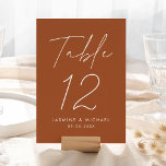 Modern Script Terracotta Wedding Table Number Card<br><div class="desc">Simple, modern wedding table number cards featuring "Table" displayed in a handwritten white script with a terracotta background (or a color of your choosing). To order the terracotta wedding table cards: add your name, wedding date, and table number. Each number needs to be added to your cart individually. After you...</div>