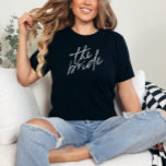 Modern Script White And Black Bride T-Shirt<br><div class="desc">This is an elegant "the bride" shirt featuring a beautiful calligraphy font. All colors are editable, but the wording is not editable // For matching items, please visit the "BRIDE" collection in the By Nicole Designs Zazzle store. * If you like this design but don't see it available for something...</div>