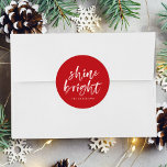 Modern Shine Bright Script Red Holiday Classic Round Sticker<br><div class="desc">Add a festive touch to your holiday envelopes and gift boxes with our Shine Bright holiday stickers. The custom holiday stickers feature the words "Shine Bright" in a white,  modern hand-lettered script and a red background. Personalize the stickers by adding your name or custom text below.</div>