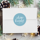 Modern Shine Bright Winter Blue Holiday Classic Round Sticker<br><div class="desc">Add a festive touch to your holiday envelopes and gift boxes with our Shine Bright holiday stickers. The custom holiday stickers feature the words "Shine Bright" in a white,  modern hand-lettered script and a sky blue background. Personalize the stickers by adding your name or custom text below.</div>
