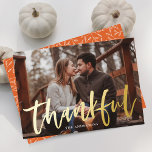 Modern Thankful Script Orange Photo Thanksgiving Foil Holiday Card<br><div class="desc">Modern Thanksgiving card featuring your horizontal photo with "Thankful" displayed in gold foil brush script lettering with your family name displayed below. The foil Thanksgiving card reverses to feature a white foliage pattern with an orange background.</div>