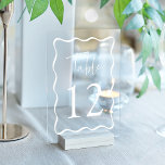 Modern White Wavy Frame Acrylic Table Numbers<br><div class="desc">Elevate your wedding decor with these Modern Wavy Frame Acrylic Wedding Table Numbers! Featuring a unique retro design, each table card showcases “Table” in a stylish handwritten white script with the table number below. A chic white wavy border surrounds the number, creating a striking contrast against your choice of a...</div>