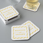Modern Yellow Wavy Frame Wedding Square Paper Coaster<br><div class="desc">Add a stylish touch to your wedding reception, rehearsal dinner, engagement party, or wedding shower with these Modern Yellow Wavy Frame paper coasters. The retro wedding coasters display the couple's names in bold yellow lettering surrounded by a yellow wavy border contrasting with a white background. The trendy wedding coasters were...</div>