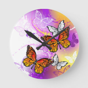 Monarch Butterflies on Purple Background Round Clock