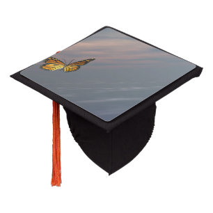 Monarch butterfly flying upon the ocean graduation cap topper