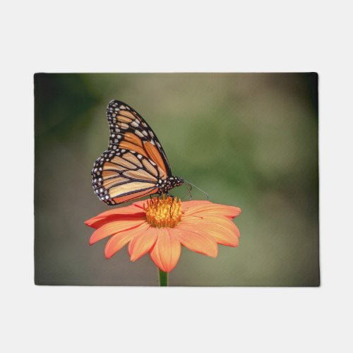 Monarch Butterfly on an orange flower Doormat