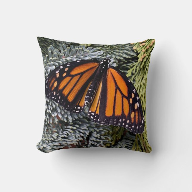 Monarch butterfly on evergreens throw pillow (Front)