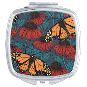 Monarch butterfly on red coneflowers compact mirror