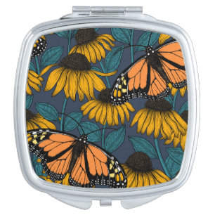 Monarch butterfly on yellow coneflowers compact mirror