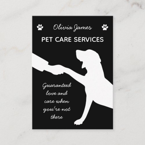 Monochrome dog paw in hand pet care services business card