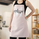 Monogram Brush Calligraphy Blush Pink Apron<br><div class="desc">In the realm of culinary arts, individuality and style are as significant as the flavors you create. Our personalized apron, adorned with a tastefully designed monogram and your name, serves as an emblem of your unique culinary identity. The font duo—comprising an elegant serif font for the monogram and a modern...</div>