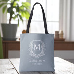 Monogram Dusty Blue Crest Botanical Wedding  Tote Bag<br><div class="desc">Bring soft elegance to your celebration with our Monogram Dusty Blue Crest Botanical Wedding Tote Bag. Featuring a serene dusty blue background, a refined botanical crest, and your personalized monogram, this tote blends timeless charm with modern style. Perfect for wedding welcome bags, bridal party gifts, or guest favors, it offers...</div>