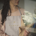 Monogram Gold Gray | Minimalist Elegant Modern Apron<br><div class="desc">A simple stylish custom monogram design in a gold modern minimalist typography on an elegant minimalist soft taupe gray background. The monogram initials and name can easily be personalized along with the feature line to make a design as unique as you are! The perfect bespoke gift or accessory for any...</div>