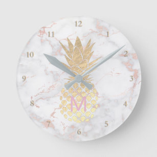 Monogram golden pineapple on pink marble round clock