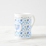 Monogram Hanukkah Festival Menorah Lights Bone China Mug<br><div class="desc">Hanukkah Menorah Lights Holiday label. Monogram and Hanukkah Logo Decoration with traditional symbols pattern. Home & Living > Kitchen & Dining > Drinkware > Mugs & Cups. Israel,  Jerusalem. Sofiartmedia Modern Design.
Judaica Modern Design with text template. Personalize them by adding name or wishes text.</div>