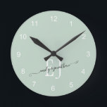 Monogram Initials Names Elegant Script Sage Green Round Clock<br><div class="desc">Newlywed Monogram Initials Names Elegant Script Newlywed Sage Green. Romantic typography with couples' initials and names which you can easily personalise.</div>