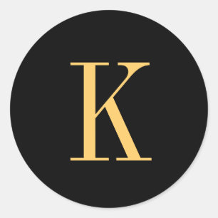 Monogram K gold-colored on black background Classic Round Sticker