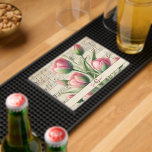 Monogram Pink & Green Vintage Tulips Sheet Music Bar Mat<br><div class="desc">Add a touch of timeless elegance to your home bar or entertaining space with the Monogram Pink & Green Vintage Tulips Sheet Music Bar Mat. This sophisticated design features a delicate watercolor illustration of pink tulips accented with soft green leaves, beautifully set against an aged sheet music background with faded...</div>