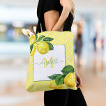 Monogram rustic country lemon watercolor polka dot tote bag<br><div class="desc">Make a stylish impression with this beautiful, chic, simple, modern, custom monogram name tote bag. Fresh, rustic, country watercolor lemons and green leaves, along with grass green handwritten script typography, overlay white polka dots on a light yellow background. Personalize with your name and monogram initial. Makes a fashionable statement every...</div>