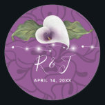 Monogram White and Purple Calla Lily Wedding Classic Round Sticker<br><div class="desc">Create your own elegant calla lily stickers personalized with your calligraphy script monogram initials and wedding date. The rustic watercolor art by Raphaela Wilson portrays a heart shaped white and purple calla lily flower with a gold stamen, greenery leaves, and romantic string lights. The background is a lovely shade of...</div>