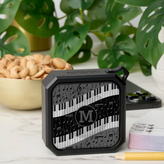 Monogrammed curve piano keys and musical notes bluetooth speaker