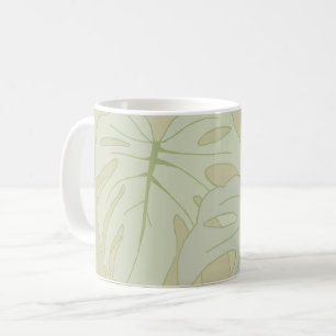 Monstera foliage in soft green coffee mug