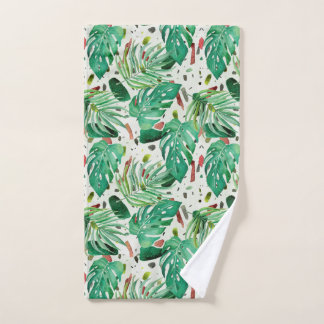 Monstera leaves and palm leaves on terazzo backgro hand towel