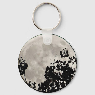 Moon behind dark leaves keychain