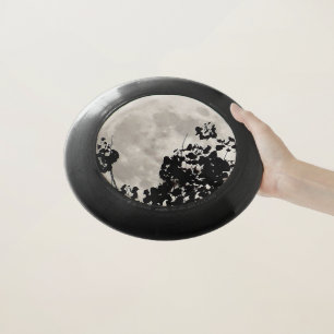 Moon behind dark leaves Wham-O frisbee