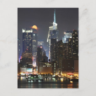 Moon rises over midtown New York. Postcard