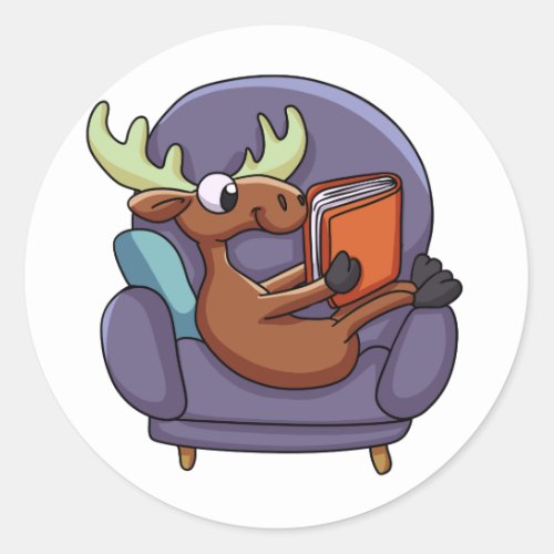 Moose reading a book on a sofa  choose back color classic round sticker