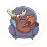 Moose reading a book on a sofa | choose back color classic round sticker