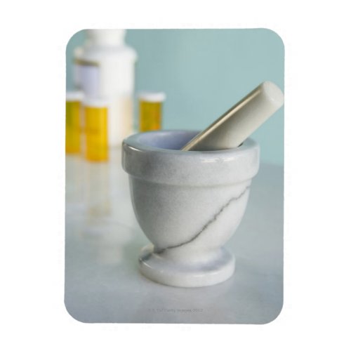 Mortar and pestle pill bottles in background magnet