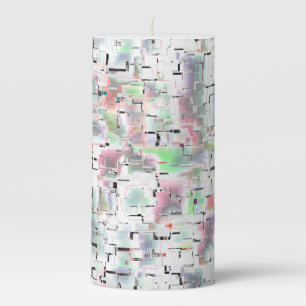 Mosaic of paper in opaque colors and small drizzle pillar candle