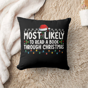 Most Likely To Read A Book Through Christmas Throw Pillow