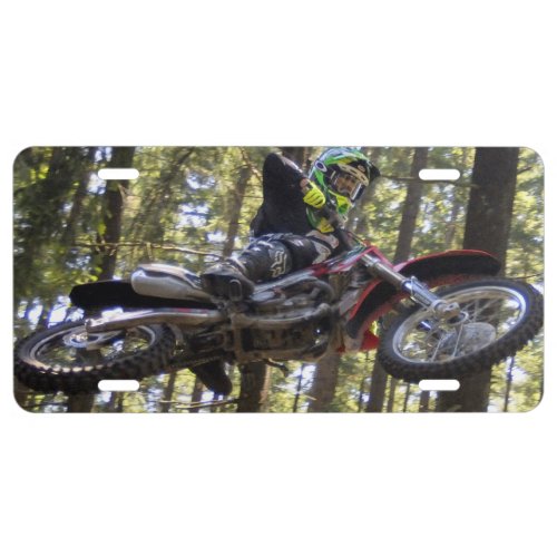 Motocross rider flying high in the trees license plate