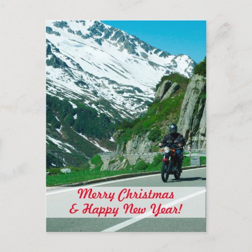 Motorcycle rider in snowy mountains Christmas Postcard