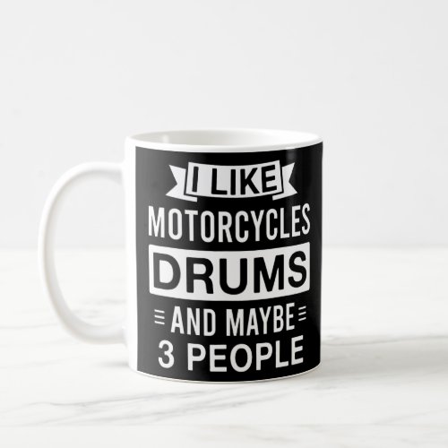 Motorcycles and drums and maybe 3 people  coffee mug