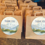 Mountain Lake Watercolor Wedding Thank You Classic Round Sticker<br><div class="desc">Mountain Lake Watercolor wedding thank you stickers with bride and groom's names. Scenic watercolor wedding favor stickers in shades of dusty blue and green. The lakeside scene features mountains, greenery and pine trees, the lake and a light sky. If you would like matching products, please browse my Mountain Lake collection....</div>