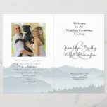 Mountains Folded Wedding Photo Program Template<br><div class="desc">Misty mountains folded wedding program template with a photo area. Blue-gray mountain scenery covers the bottom third of the paper on all the pages. Customize text on front and back of 8.5 x 11 inch paper that will be folded in half after purchase. The photo of the couple will appear...</div>