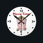 Movie Popcorn Wall Clock<br><div class="desc">Fun movie room clock done with a white background and black numbers. Cartoon graphics of a box of movie popcorn, in the middle, and red text reading Movie Time. Personalize the text to change it. Makes a great gift idea.</div>